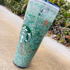 the starbucks cup is covered in green glitter