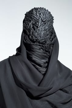 a man wearing a black scarf and head covering