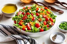 a salad with tomatoes, lettuce and other ingredients