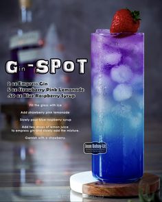 a blue and purple drink with a strawberry on top