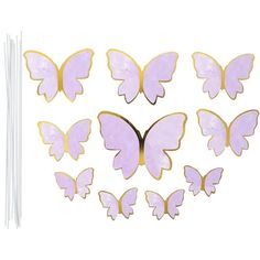 purple and gold butterfly cutouts with sticks in the middle on a white background, set of 12