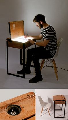 a man sitting at a desk writing on a piece of wood with a hole in it