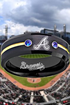 a baseball stadium with the atlanta braves logo on it's black band and two blue sapphire stones