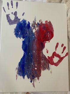 a hand and foot print on a canvas with red, white and blue paint in it