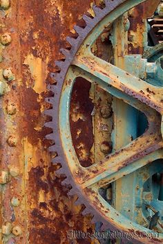 an old rusted metal structure with gears