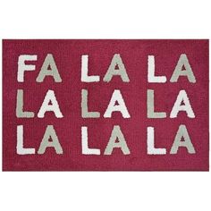 a red door mat that says fa la la la with white letters on the front