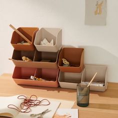 a wooden table topped with lots of boxes and utensils