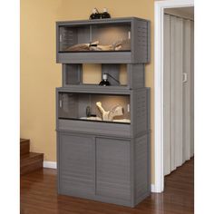 three shelves with shoes on top of them in front of a door and stairs leading up to the second floor