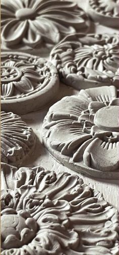 an intricately carved surface with flowers and leaves