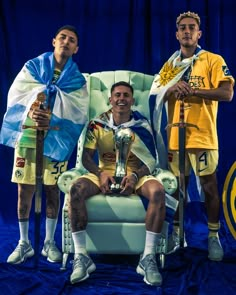 three men sitting on a chair with their arms around each other