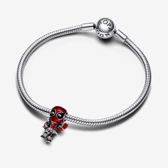 Pay tribute to a brave and goofy character with the Marvel Deadpool Charm. Marvel's Deadpool is depicted in sterling silver with metallic-effect enamel in basse-taille technique revealing a woven pattern beneath Deadpool's fully-equipped body suit. Intricate detailing brings this charm to life, showing Deadpool mid-action with one hand forming a peace sign. No Marvel fan's collection is complete without this charm that celebrates the goofy and brave-hearted Deadpool character. - Pandora Marvel D Pandora Marvel, Goofy Character, Deadpool Character, Pandora Essence, Pearl Diamond Jewelry, Custom Charm Bracelet, Gold Armband, Solid Gold Necklace, Marvel Deadpool