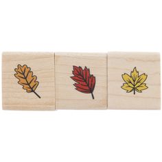 four wooden stamps with leaves on them