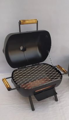 an outdoor bbq grill with tongs on it