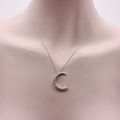 This is part of Chairish’s Fine Jewelry assortment.  This 18k white gold crescent moon necklace is encrusted with sparkling diamonds. The crescent moon has a rounded shape, with wonderful dimension—when it hangs from the chain it has depth that draws the eye to this excellent piece. Circa 1980’s, this vintage necklace is Italian made. It provides a great contrast when paired with yellow gold, offering a nice cool pop, as if glowing “by the light of the silvery moon.”   There are 29 single cut di Silver Crescent Necklace In Fine Jewelry Style, Silver Necklace With Moon Charm For Formal Occasions, White Gold Crescent Diamond Necklace For Gift, Silver Crescent Fine Jewelry Necklace, Silver Crescent Necklace Fine Jewelry, White Gold Crescent Necklace In Fine Jewelry Style, Elegant Silver Half Moon Necklace, Luxury Silver Crescent Jewelry, White Gold Crescent Necklace Fine Jewelry