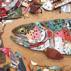 there is a fish made out of scraps on the ground next to other items