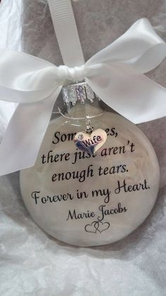 a glass ornament with a white ribbon on it that says, sometimes there isn't enough tears forever in my heart