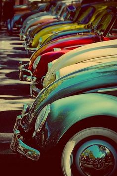 many different colored cars lined up in a row