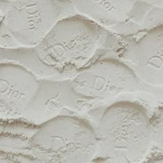 the texture of white paint with circles and words on it's surface is shown in close up