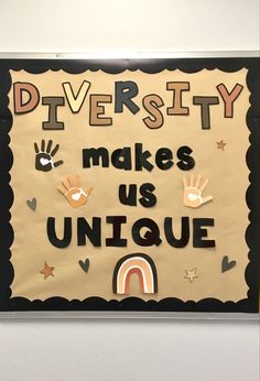 a bulletin board that says diversity makes us unique with handprints on the front