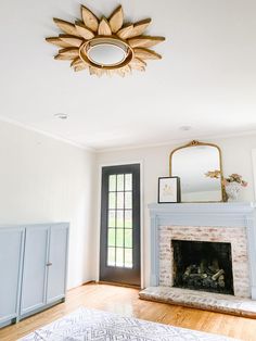 a living room with a fireplace and mirror