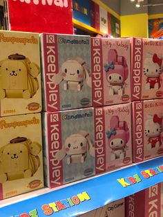 several boxes of hello kitty toys are on display