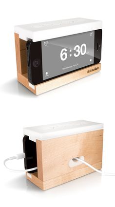 an alarm clock is plugged into a wooden box and connected to a charger