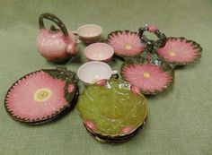 a collection of pink and green glass items