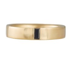 a gold ring with a black stone in the middle and a thin band around it