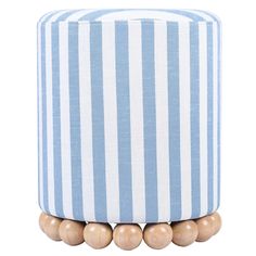 a blue and white striped ottoman with wooden beads on the bottom, in front of a white background