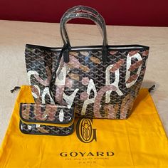 New Goyard Saint Louis Pm Limited Edition Lettres Camouflage - From The 2023 Limited Edition Lettres Camouflage Collection; Sold Out - Classic Signature Chevron Of The Goyardine Canvas - Black Calfskin Trim - Lettres Camouflage In Pink Version - Made In France - Comes W/ Goyard Pouch, Tag, Info. Booklet, And Dust Bag - See Detailed Photos For More Information - Sample Photo At End To Show Design/Style - No Trades; No Offers; Firm Price Goyard Pouch, Khaki Tote Bag, Goyard Saint Louis Pm, Goyard Saint Louis, Show Design, Grey Tote Bags, Camouflage Colors, Dog Tote, Goyard Bag