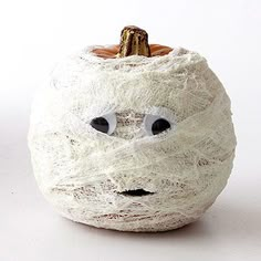 there is a white pumpkin with goo eyes