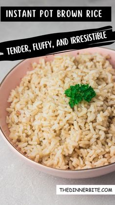 a pink bowl filled with rice and topped with a green leafy piece of parsley