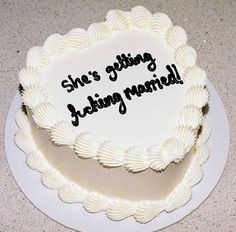 there is a white cake with black writing on it