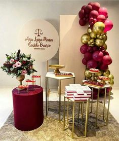 some tables and stools are set up in front of a wall with balloons on it