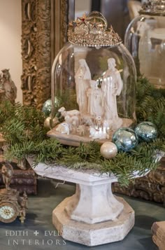 a snow globe with christmas decorations and ornaments around it