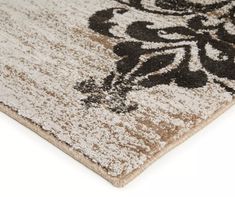 a brown and white area rug with an ornate design on the bottom, in front of a white background