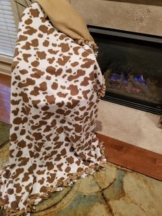 an animal print blanket sitting on top of a fireplace