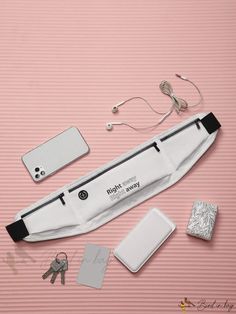 a hairdryer and other items laid out on a pink surface with a cell phone