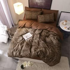 a leopard print comforter set on a bed in a room with white rugs