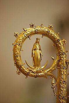 an ornate gold sculpture with a person in the center