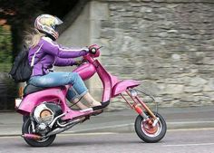 a woman riding on the back of a pink scooter