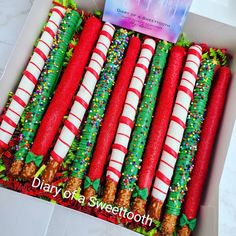 a box filled with candy canes on top of a table