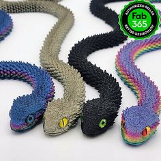 several different colored snakes on a white surface with a green tag that says rob's 365