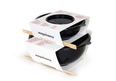 three black pots stacked on top of each other with chopsticks sticking out of them