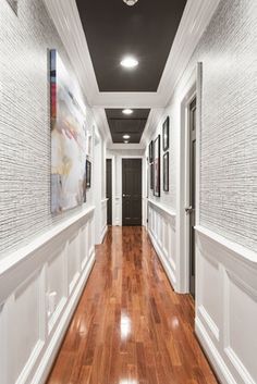 the hallway is clean and ready for guests to use it as an entrance way in this home