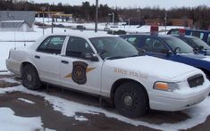 a police car is parked in the snow