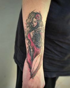 a woman with a skeleton tattoo on her arm