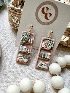 a pair of earrings sitting on top of a table next to eggs and other items