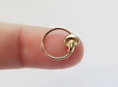 a small gold ring on someone's finger