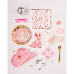 pink and gold items are arranged on a white surface with confetti, napkins, and other decorations